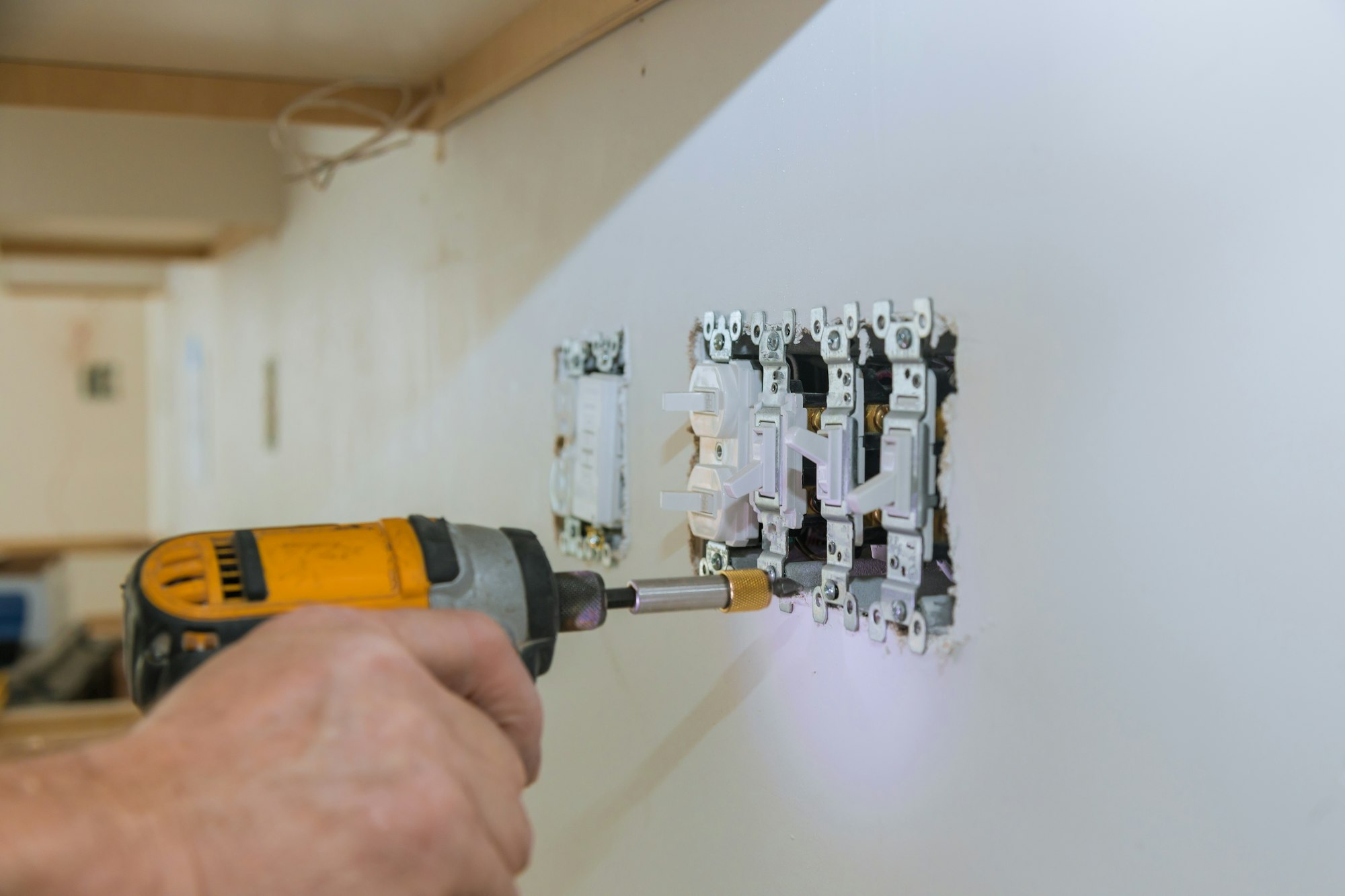 Work on installing electrical outlets with electrical wires and connector installed in plasterboard